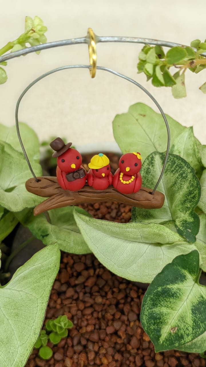 Miniature Bird Family on Branch