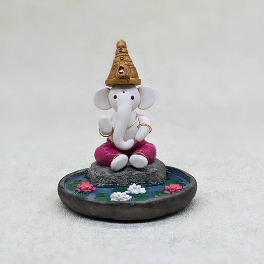 Miniature Ganesha seated in lotus pond